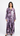 Woman wearing a long, patterned dress on a white background