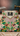 Decorative product with intricate floral patterns and a brand label on a textured surface.
